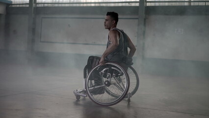 Obraz na płótnie Canvas Athlete in wheelchair with disability grabbing ball and passing to team member. Disabled person training sport
