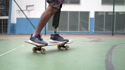 Amputee skateboarder riding skateboard with prosthetic leg