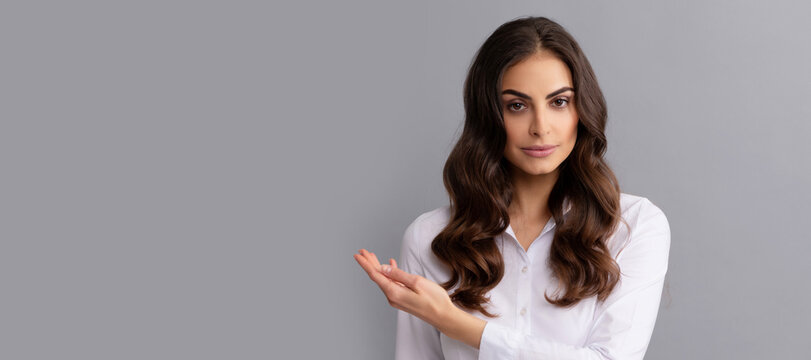 Serious Business Woman Show Open Hand For Copy Space Grey Background, Presenting Product. Woman Isolated Face Portrait, Banner Header Poster With Mockup Copyspace.