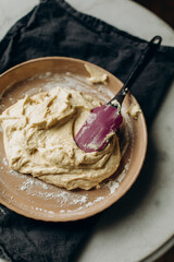 spread the raw dough with a silicone spatula in a pie dish. laying out the dough for the pie before baking