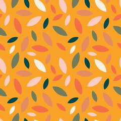 Autumn leaf fall on a yellow mustard background. Seamless cute pattern with leaves or grains in different colors. 
