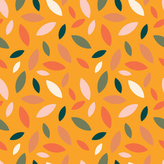 Autumn leaf fall on a yellow mustard background. Seamless cute pattern with leaves or grains in different colors. 