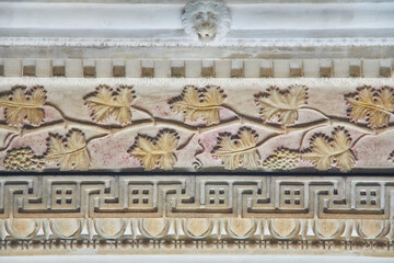 graceful beautiful historical bas-reliefs on the facade of the building