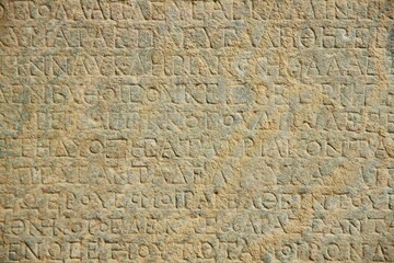 Ancient inscriptions on stone, close-up. Historical research and archaeology.