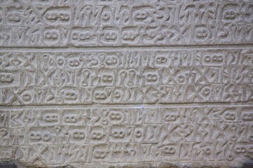 Ancient inscriptions on stone, close-up. Historical research and archaeology.