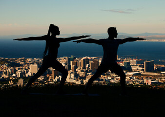 Fototapeta na wymiar Yoga, silhouette and city with a couple outdoor for exercise, workout and training. Health, wellness and fitness with a man and woman exercising outside together on an urban background in the evening