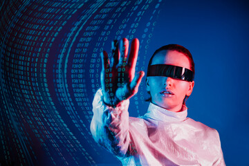 Woman dressed in holographic clothes and futuristic eyeglasses with reflection of matrix code is...