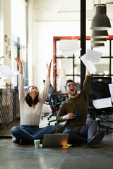 Colleagues in office. Businesswoman and businessman sitting on the floor. Colleagues working on the project