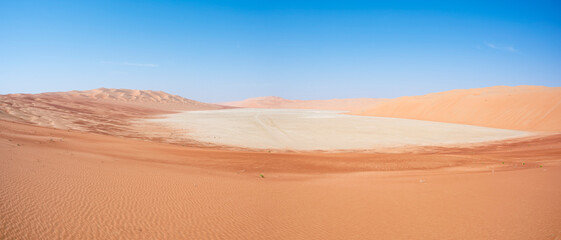 Fototapeta na wymiar Sand dunes alternating with continental sabkha filled with salt flats. Abu Dhabi Emirates, United Arab Emirates, Middle East
