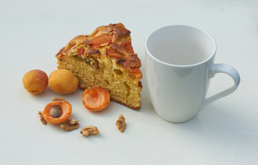 Apricot pie with fresh fruits on a wooden table. High quality photo