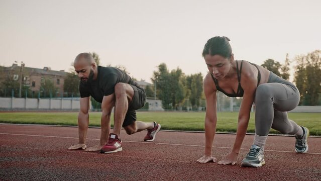 Athletic man and woman exercise stretching performing lunges
