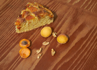 Apricot pie with fresh fruits on a wooden table. High quality photo