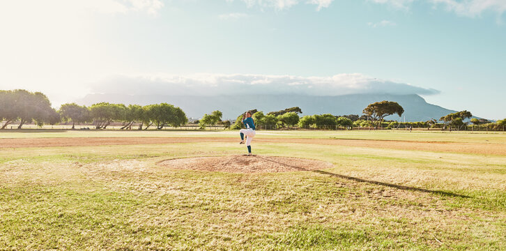 Panoramic of pitcher on field for a game of baseball, ready to pitch and throw the ball. Baseball player standing alone on pitchers mound on baseball field for practice, training and sports match