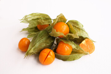 Close-up photo of the berries of the physalis plant. Bright orange fruits on a white background.