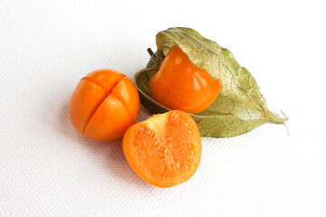 Close-up photo of the berries of the physalis plant. Bright orange fruits on a white background.
