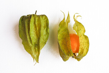 Close-up photo of the berries of the physalis plant. Bright orange fruits on a white background.