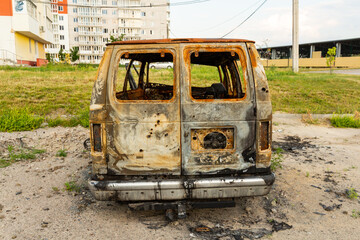 Damaged and destroyed civilian car with shrapnel holes from Russian missile in a war zone in...