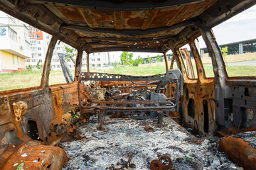 Damaged and destroyed civilian car with shrapnel holes from Russian missile in a war zone in...