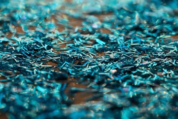 Beautiful bright, shiny, turquoise or blue glitters, selective focus.