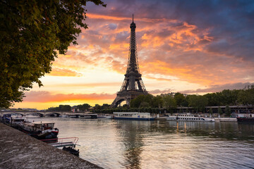 Fototapeta na wymiar Eiffel Tower by the Seine River in Paris at sunrise. France