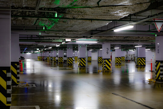 Empty underground parking lot, huge spacious heated parking space, horizontal photo
