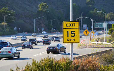 Traffic speed limit to 15mph for exit on right lane at the end of Golden Bridge highway from San...