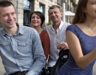 family of tourists enjoy a walk on the bike carriage