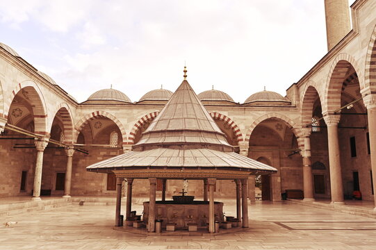 Istanbul,  Turkey - 9 22 2019: The yard of Fatih mosque including the ablution place and the arches around 