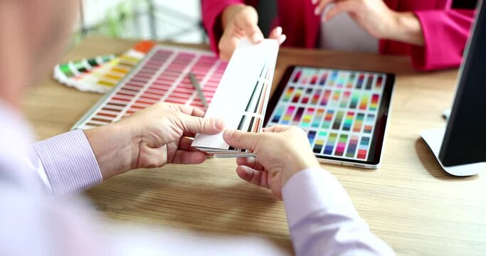 Designer giving client color samples for decor of apartments closeup 4k movie slow motion 
