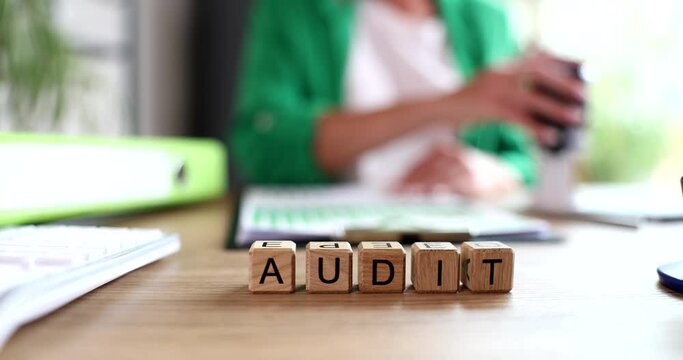 Word audit is written on background of businessperson working in office closeup 4k movie slow motion 
