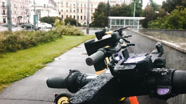 scooters rental transport city rainy wet weather eco bike High quality 4k footage. parking license stop