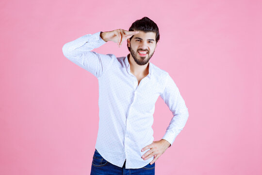 Man in a white shirt noticing and greeting someone