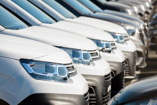 Montoir-de-Bretagne, France - September 22, 2022: Close-up view of the front of brand new white Citroën Berlingo panel vans lined up in a row outdoors in a parking lot.
