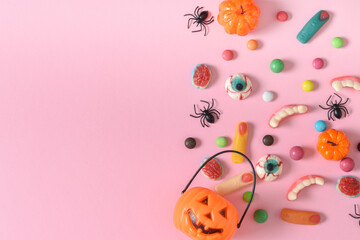 Banner with various sweets on a pink background. Happy Halloween. Space for copying. Flat position, top view