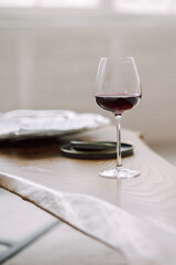 Glass of red wine on gray blurred background. High quality photo