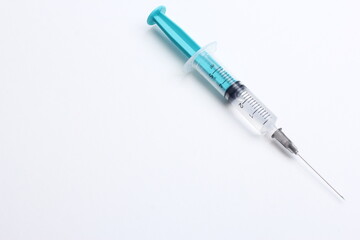 Fototapeta premium Medical syringe on a white background. A syringe for injection. The concept of health and beauty