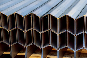 Bent metal products are stacked on a pallet. Work with sheet metal. - obrazy, fototapety, plakaty