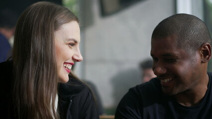 Romantic diverse couple laughing and smiling. A black man leaning on white girl shoulder showing love and affection
