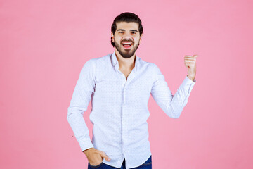 Man in a white shirt demonstrating his arm muscles