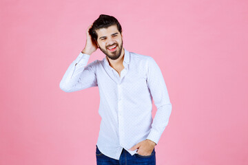 Portrait of a Man in a White Shirt Against a Pink Background
