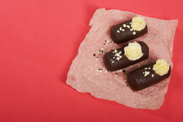 Cake potato. Decorated with butter cream. On a pink background. Shot close-up.