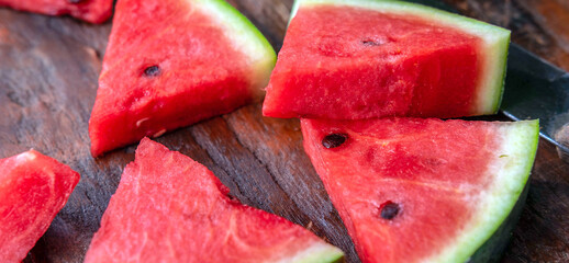 Close up of tasty sliced fresh watermelon on a wooden chopping board