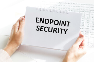 Text ENDPOINT SECURITY on brown paper notepad in businessman hands in office. Business concept