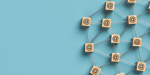 Wooden blocks with mail icon on a blue background. Information dissemination concept. 3D rendering.