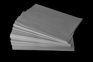 Stack white paper for writing and printing isolated on black background and texture