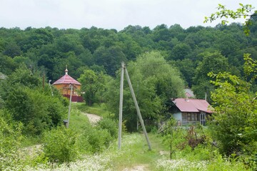 Village and old houses. Wooden church.