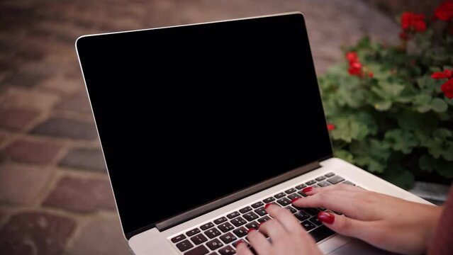 woman's palms working on a mock up screen computer, creative people can put whatever they want on computers, woman's hands typing outside on laptops with mock up screens, slow motion, hands close up,