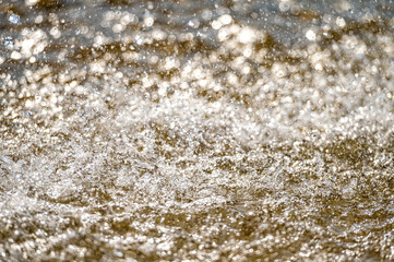 Water splash with small drops in the fountain. Abstract natural, selective focus, copy space