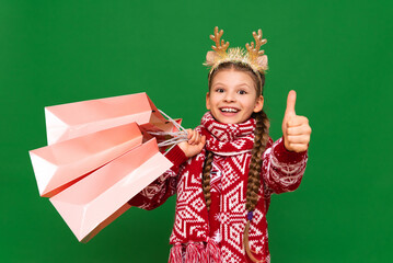 A joyful girl in a New Year's sweater is shopping for the holiday. Christmas shopping in the store.