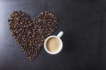 International Coffee Day celebration 01 October 2022 Coffee beans heart shape and cup on dark background, close-up still life, I love coffee concept